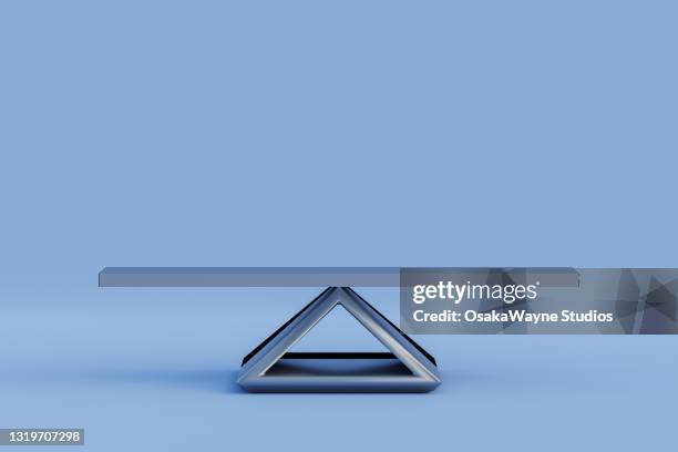 plank balancing on metal triangle. - scales balance fotografías e imágenes de stock