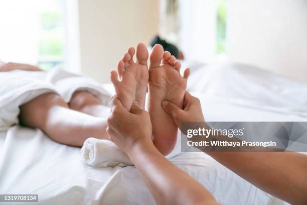 foot spa massage treatment by professional massage therapist in luxury spa resort. wellness, stress relief and rejuvenation concept - thai massage 個照片及圖片檔