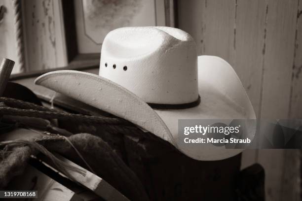 cowboy hat in natural window light - cowboyhut stock-fotos und bilder