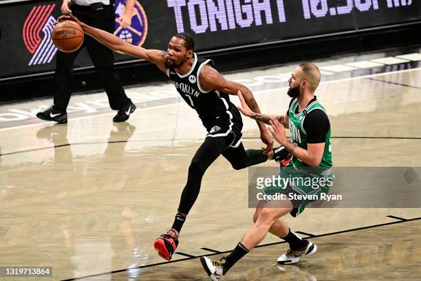 Kevin Durant of the Brooklyn Nets chases down a loose ball against Evan Fournier of the Boston Celtics in Game One of the First Round of the 2021 NBA...