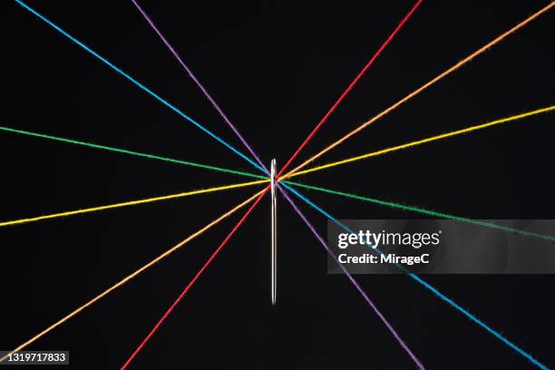 rainbow colored threads through needle eyelet - integrated solutions stock pictures, royalty-free photos & images