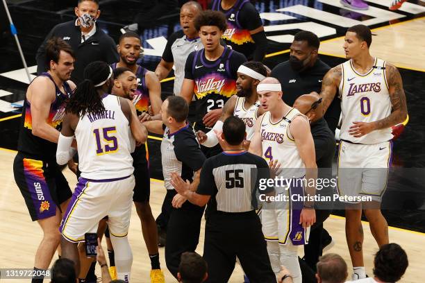 Montrezl Harrell, Alex Caruso and Wesley Matthews of the Los Angeles Lakers come together with Dario Saric, Cameron Payne and Mikal Bridges of the...