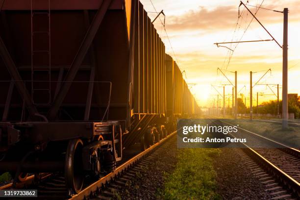 freight wagons on the railroad at sunset. rail freight and passenger transportation - 貨物列車 ストックフォトと画像