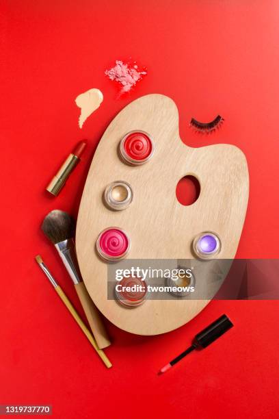 conceptual beauty product on red background still life. - lidschatten stock-fotos und bilder