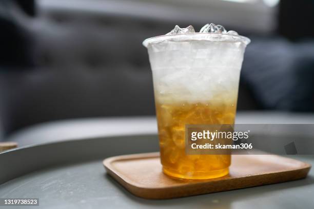 ice green tea with plastic take away cup with plastic stroll and plastic bottle - disposable cup foto e immagini stock
