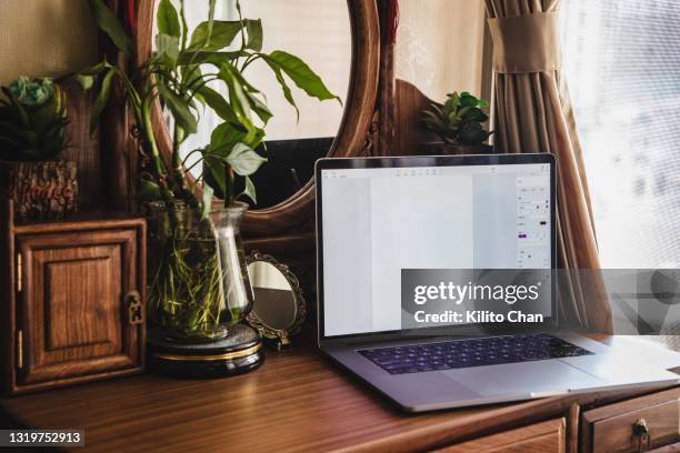 laptop on the dressing table by the window - vanity table stock pictures, royalty-free photos & images