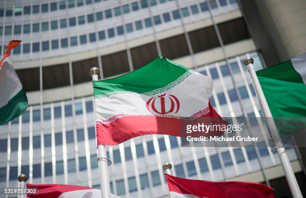 The flag of Iran is seen in front of the building of the International Atomic Energy Agency Headquarters ahead of a press conference by Rafael...