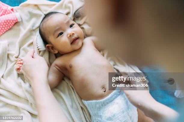 asian newborn baby very happy and enjoy with her mother changing diaper after take a bath - diaper bag stock pictures, royalty-free photos & images