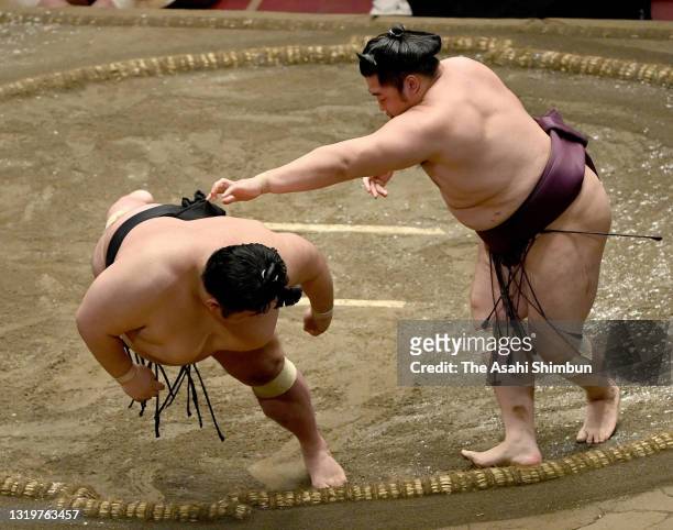 Endo throws ozeki Takakeisho to win during day thirteen of the Grand Sumo Summer Tournament at Ryogoku Kokugikan on May 21, 2021 in Tokyo, Japan.