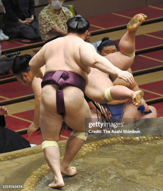 Endo throws ozeki Takakeisho to win during day thirteen of the Grand Sumo Summer Tournament at Ryogoku Kokugikan on May 21, 2021 in Tokyo, Japan.