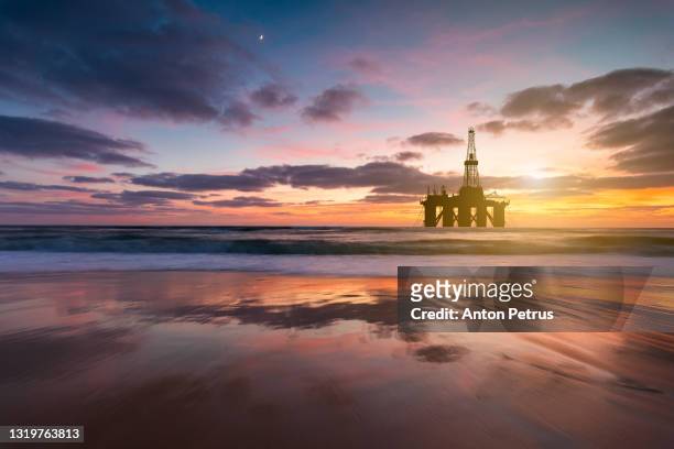 oil platform at sea at sunset. world oil industry - oil production platform stock pictures, royalty-free photos & images