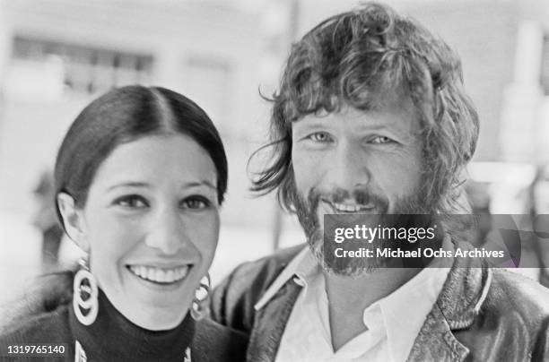 American singer Rita Coolidge, wearing a black turtleneck sweater with hoop earrings and necklaces, with her husband, American singer-songwriter and...