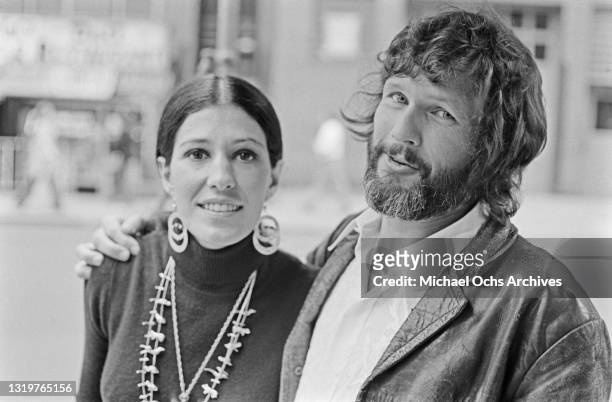American singer Rita Coolidge, wearing a black turtleneck sweater with double circle earrings and necklaces, with her husband, American...
