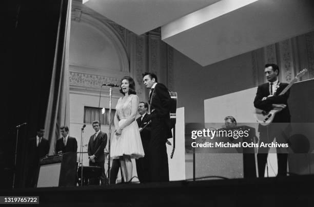 American singer-songwriter and musician June Carter Cash with her husband, American singer-songwriter and musician Johnny Cash on stage with Johnny's...