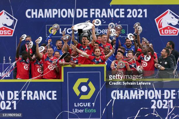 Jose Fonte and players of Lille OSC celebrate winning League 1 by receiving the trophy at their Luchin training center on May 24, 2021 in Lille,...