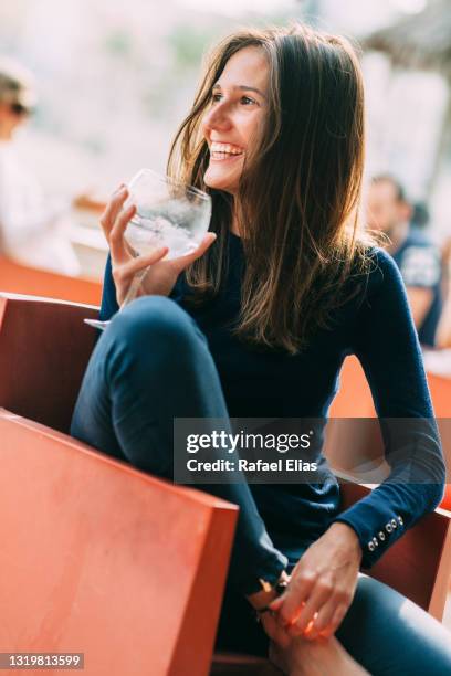 beautiful happy lady drinking gin and tonic - gin tonic stock-fotos und bilder