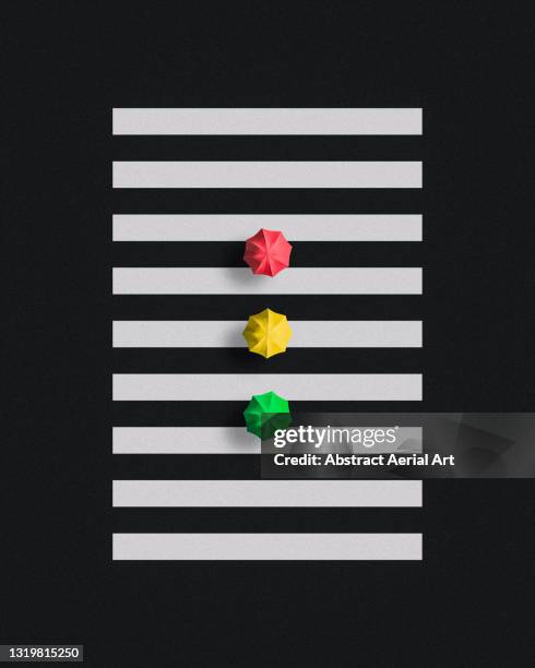 concept aerial shot looking down on three people holding umbrellas whilst walking across a zebra crossing, hong kong - paso de cebra fotografías e imágenes de stock