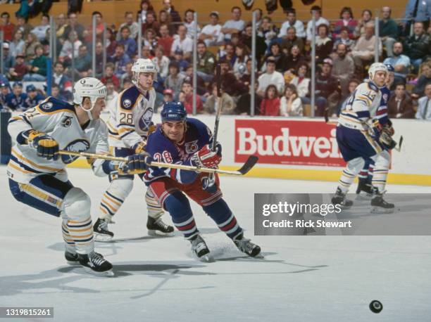 Tie Domi, Right Wing for the New York Rangers in motion on the ice against Christian Ruuttu of the Buffalo Sabres during their NHL Prince of Wales...