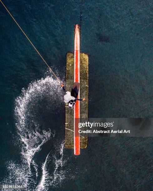 aerial shot looking down on a wakeboarder performing tricks at a wakeboard park, barcelona, spain - expertise abstract stock pictures, royalty-free photos & images