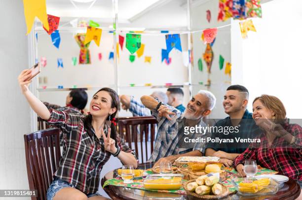 family taking a selfie at the breakfast table - hispanic month stock pictures, royalty-free photos & images