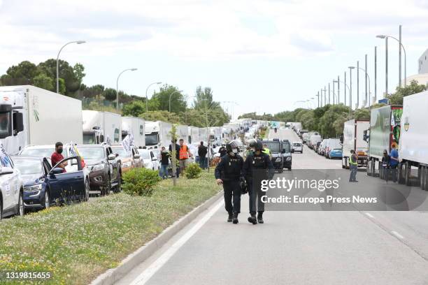 Two National Police officers in the caravan of vehicles leaving Feria de Madrid IFEMA to protest against the cut in the flow of the Tagus-Segura...