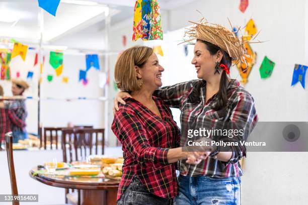 mother and daughter celebrating festa junina at home - square dancing stock pictures, royalty-free photos & images