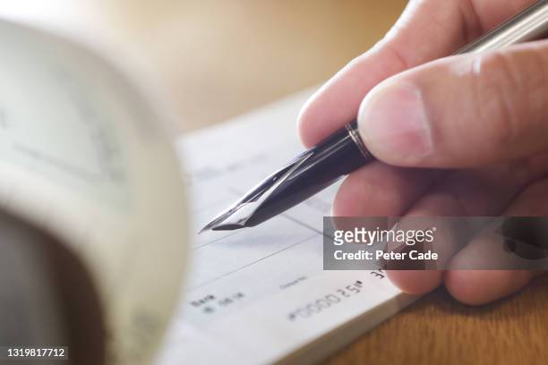 hand writing cheque - order pad stock pictures, royalty-free photos & images