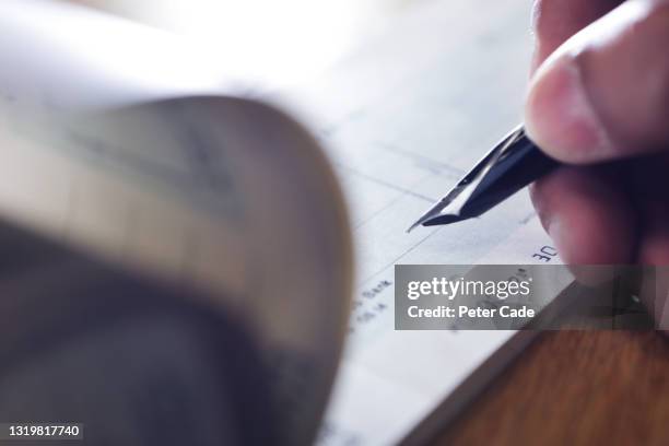 hand writing cheque - money laundering stock pictures, royalty-free photos & images