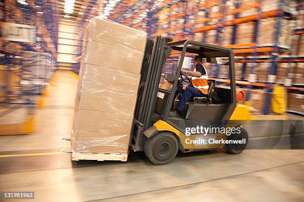 man driving forklift in warehouse - forklift 個照片及圖片檔
