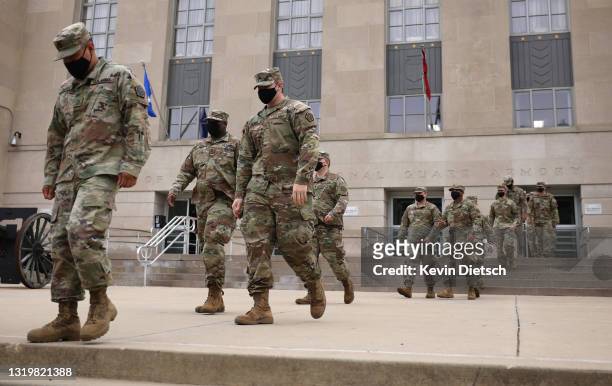 National Guard troops make their way to buses as they leave the Armory after ending their mission of providing security to the U.S. Capitol on May...