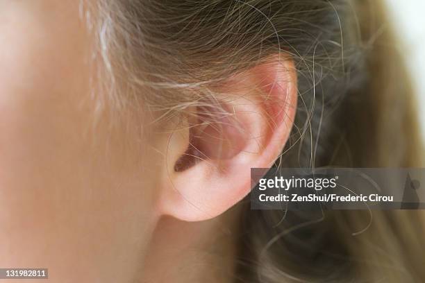 close-up of young woman's pierced ear - ear stockfoto's en -beelden