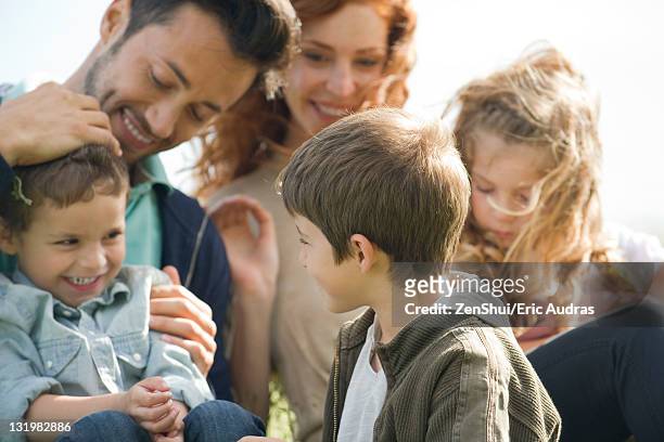 family spending time together outdoors - familia grande fotografías e imágenes de stock