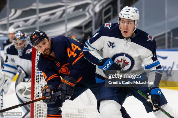 Zack Kassian of the Edmonton Oilers battles against Logan Stanley of the Winnipeg Jets during Game Two of the First Round of the 2021 Stanley Cup...