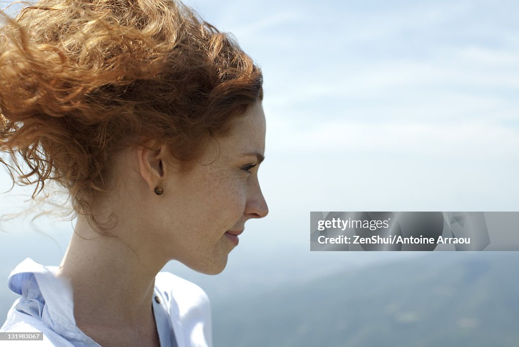 Redheaded woman looking at view, profile