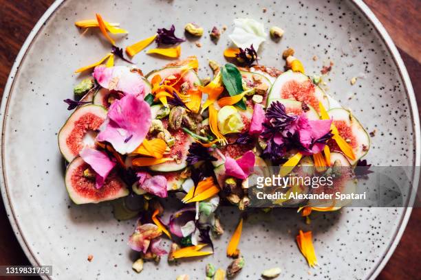 fig toast with edible flowers, directly above view - gourmet stock pictures, royalty-free photos & images