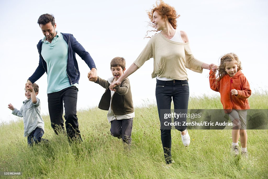 Family running together in field