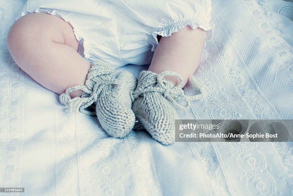 Baby with knitted booties, low section
