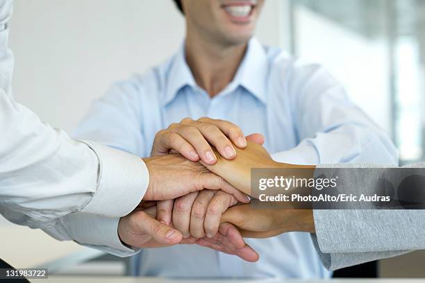 business people stacking hands - hand stack stock pictures, royalty-free photos & images