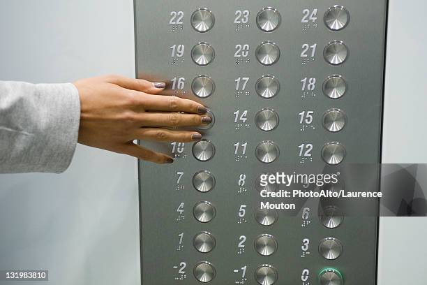 woman's hand pressing elevator button, cropped - lift button stock pictures, royalty-free photos & images