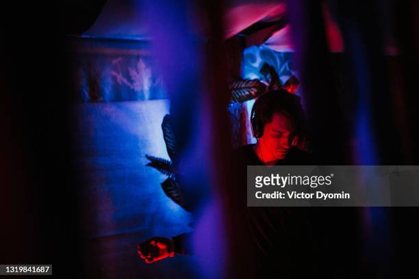 young man in the headphones play music at the party - arts culture and entertainment foto e immagini stock