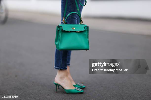 Alexandra Lapp wearing blue Citizens of Humanity jeans, green Hermès Kelly leather bag and green Manolo Blahnik mules on May 03, 2021 in Dusseldorf,...