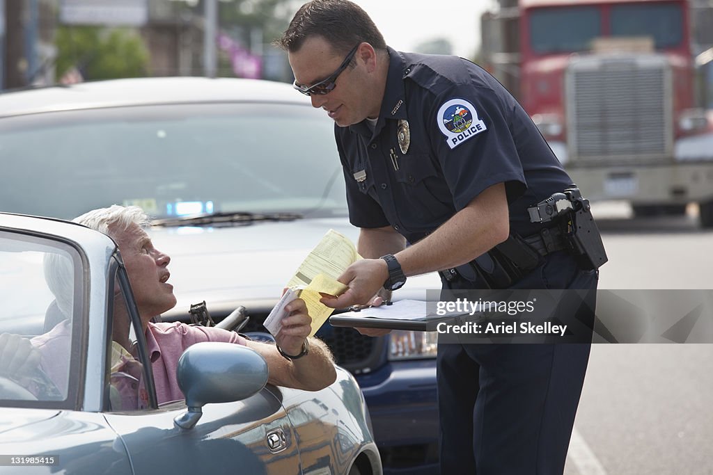 Policeman giving driver traffic citation