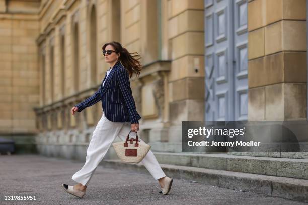 Cleo zu Oettingen-Spielberg wearing navy blue striped Polo Ralph Lauren jacket, white polo and white linen pants and beige Loewe bag via Lodenfrey...