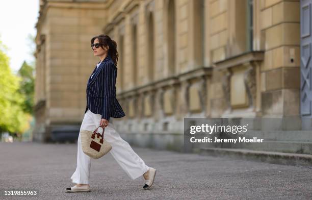 Cleo zu Oettingen-Spielberg wearing navy blue striped Polo Ralph Lauren jacket, white polo and white linen pants and beige Loewe bag via Lodenfrey...