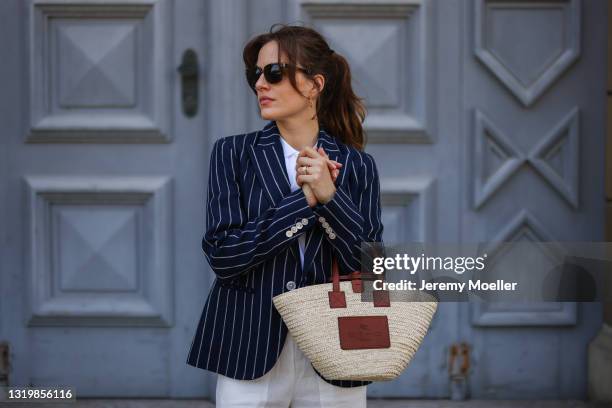 Cleo zu Oettingen-Spielberg wearing navy blue striped Polo Ralph Lauren jacket, white polo and white linen pants and beige Loewe bag via Lodenfrey...