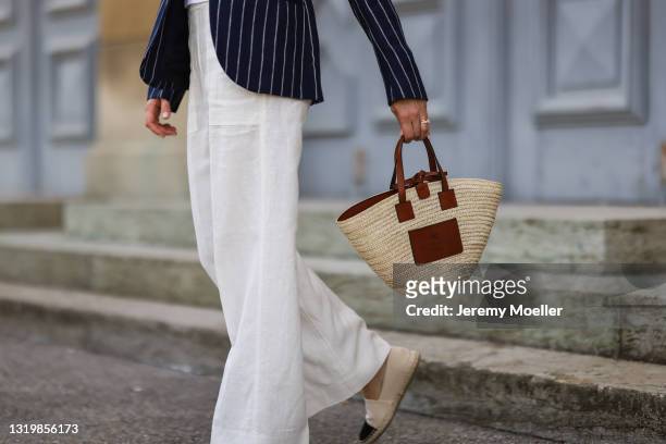 Cleo zu Oettingen-Spielberg wearing navy blue striped Polo Ralph Lauren jacket and white linen pants, beige Loewe bag and beige espadrij shoes via...
