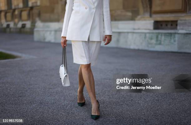 Cleo zu Oettingen-Spielberg wearing white Brunello Cucinelli blazer and shorts via Lodenfrey SS21, white Chanel bag and dark green heels on May 10,...