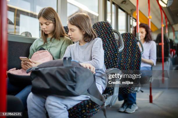 people in public bus transport - kids sitting together in bus stock pictures, royalty-free photos & images