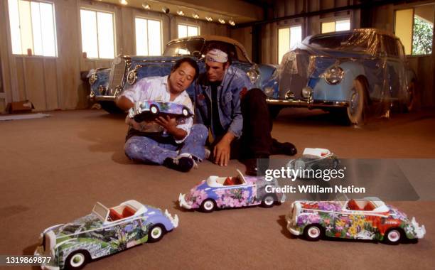 American actor, singer, writer, and director Robert Davi and a friend paint his car circa June, 1993 in Los Angeles, California.