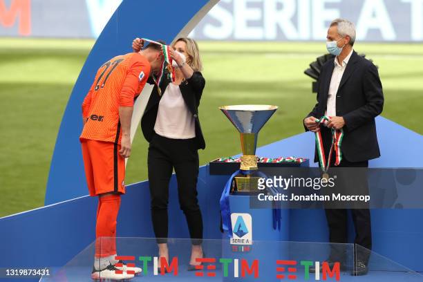 Daniele Padelli of Internazionale receives his winners' medal from Valentina Vezzali as Paolo Dal Pino looks on during the trophy ceremony following...